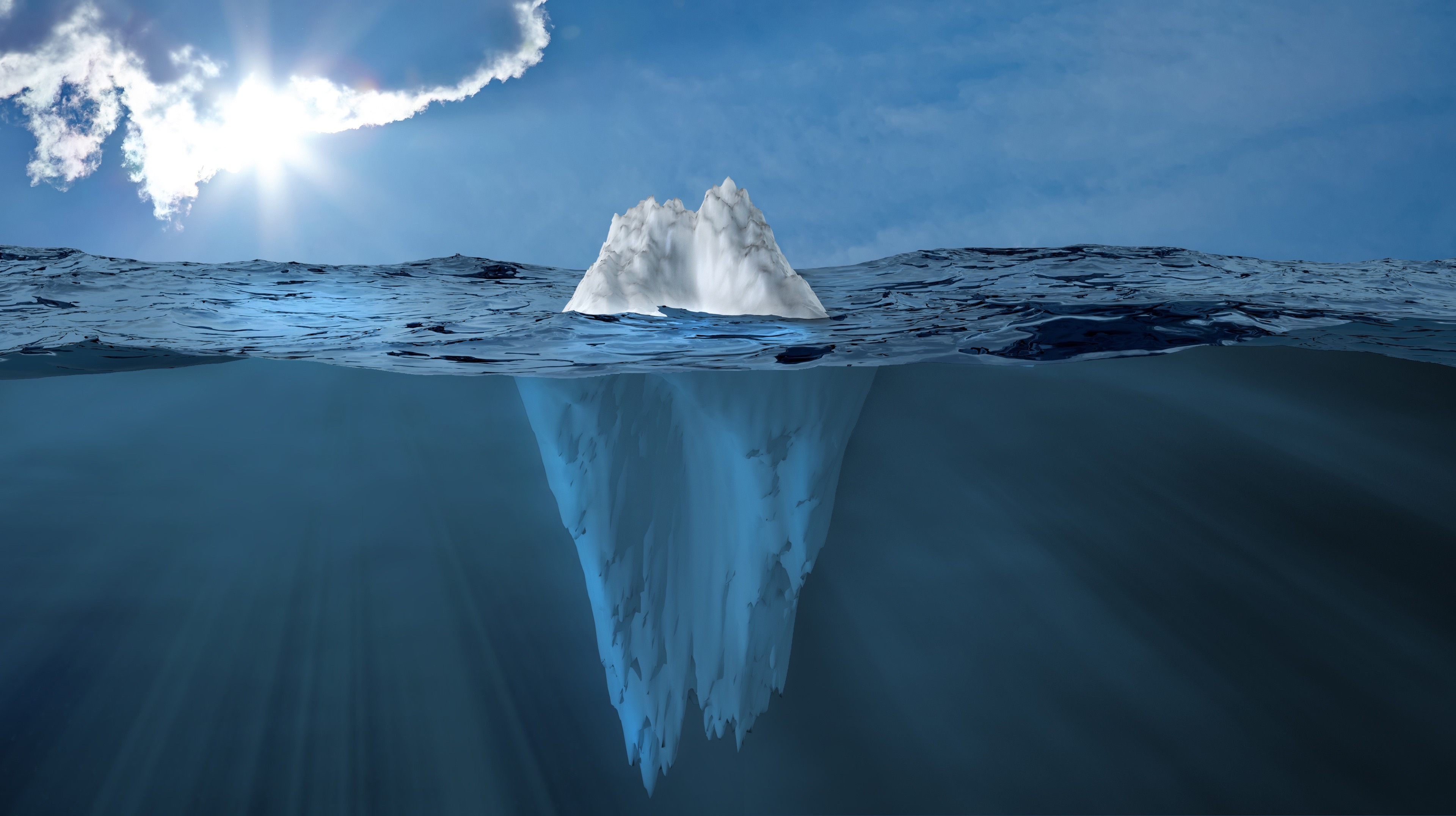 An image of an iceburg showing both what's above and below the water.